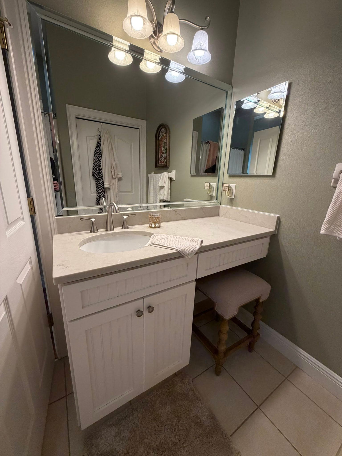 Updated bathroom vanity with quartz countertop, new sink and fixtures