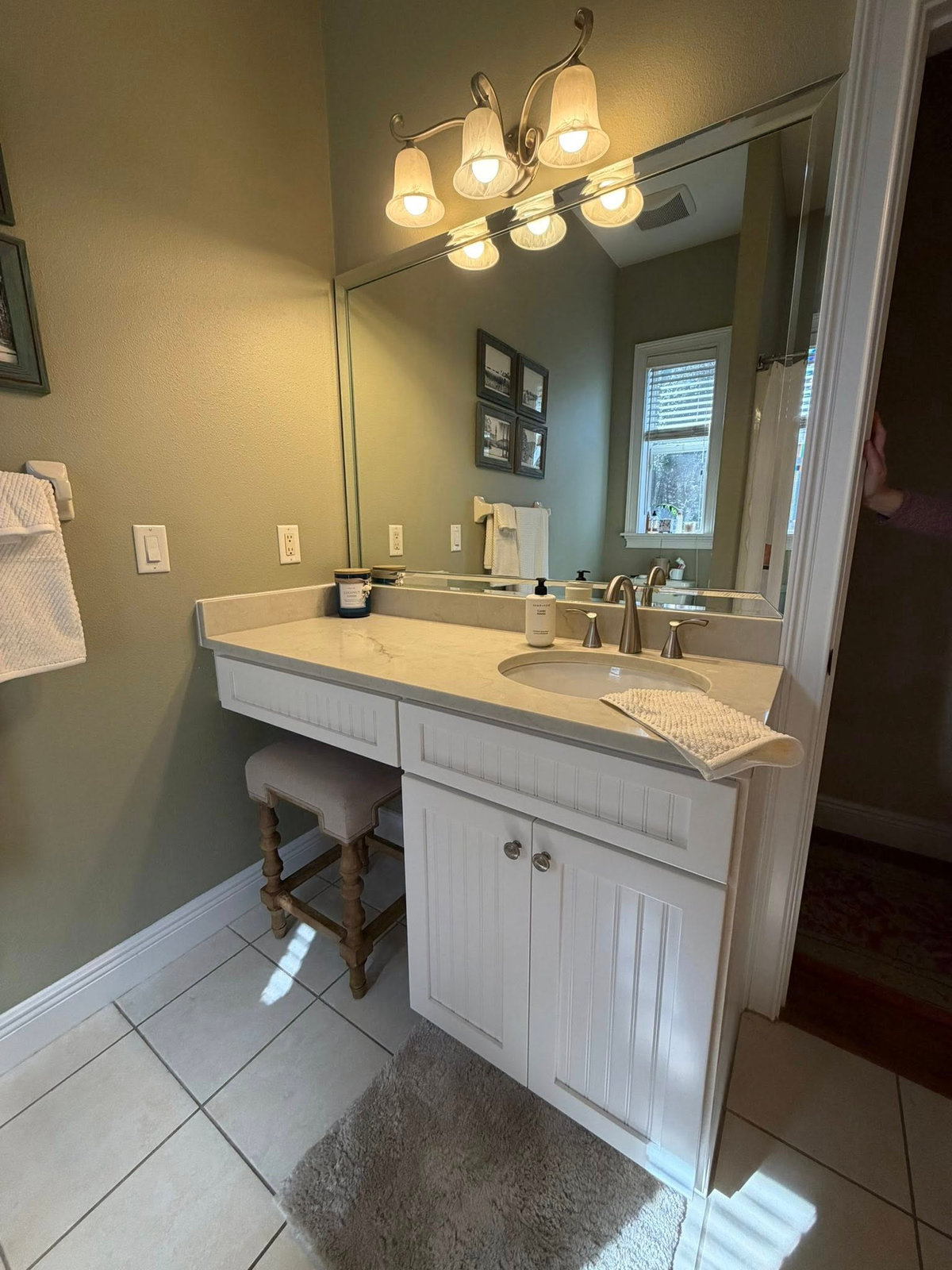 Remodeled bathroom vanity with quartz top and new fixtures