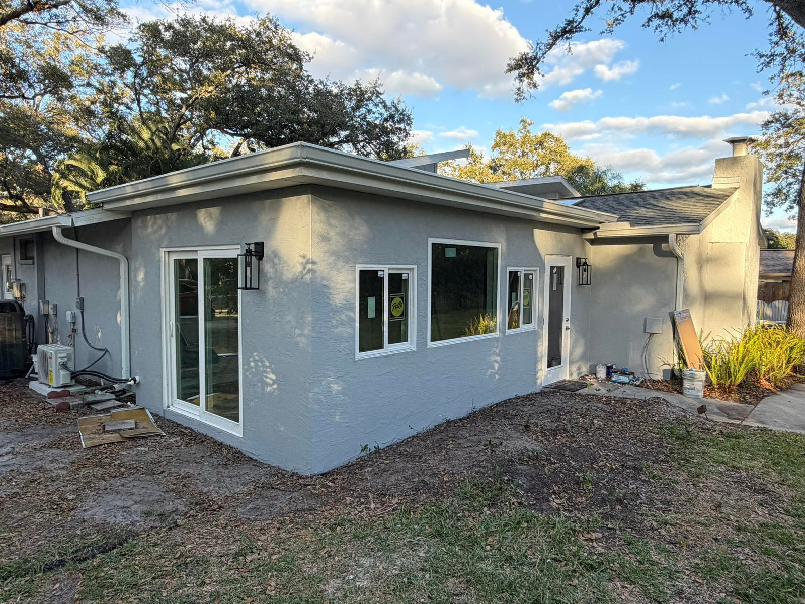 Home exterior renovation with fresh paint, new windows and doors