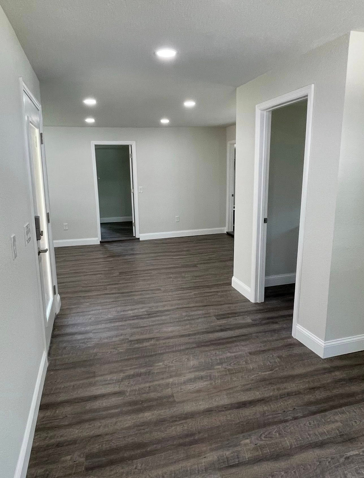 Finished interior with new plank flooring and recessed lighting