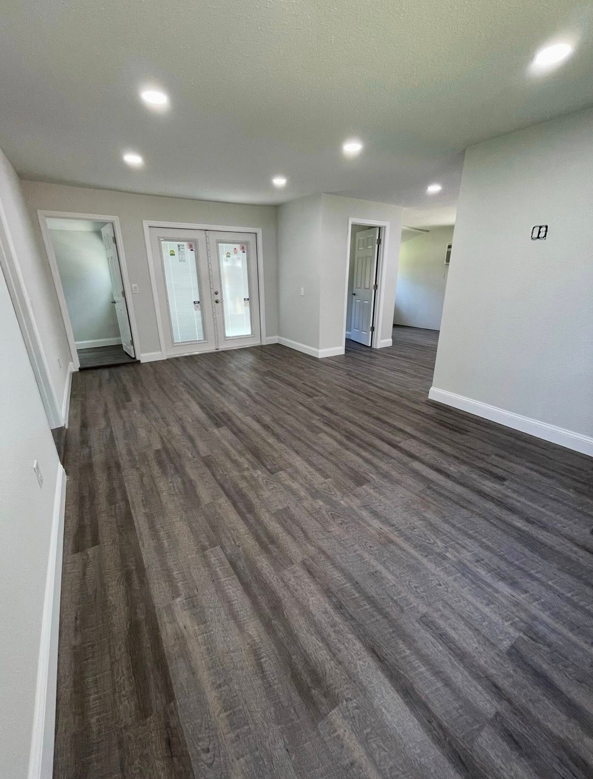Whole-home interior renovation with new flooring and recessed lighting