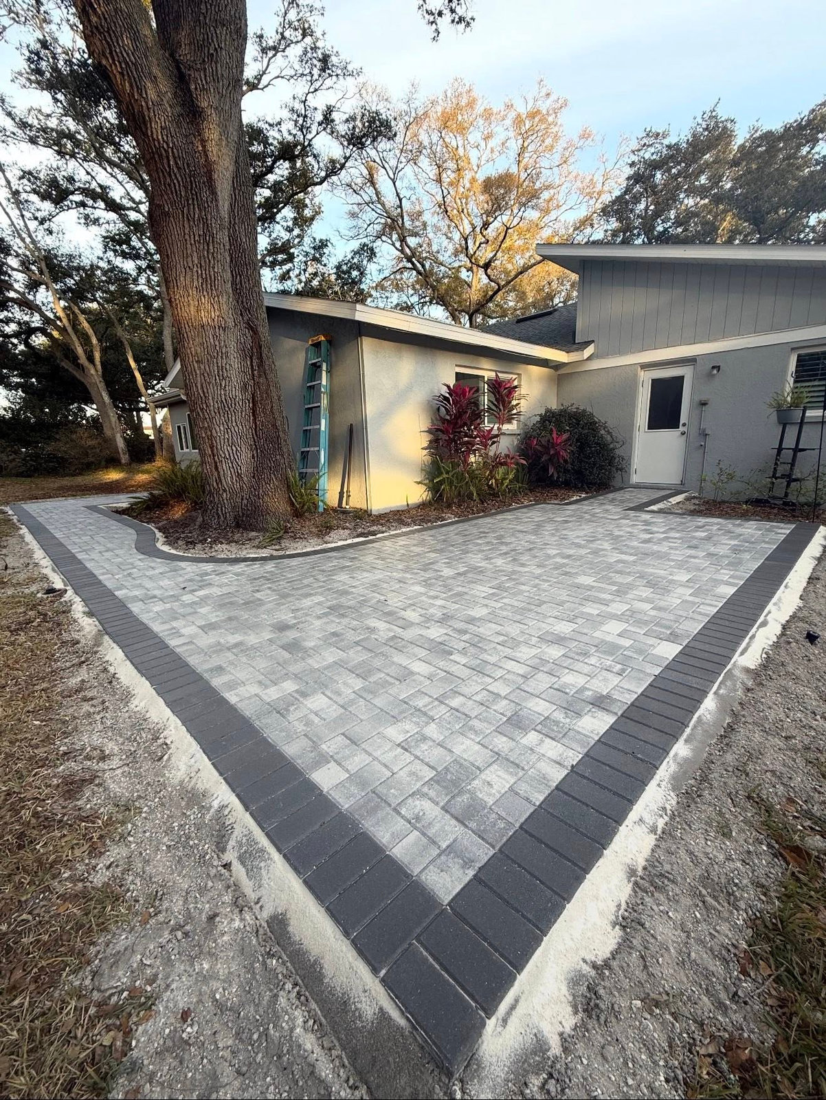 Completed brick paver driveway with charcoal border by Loucks Construction