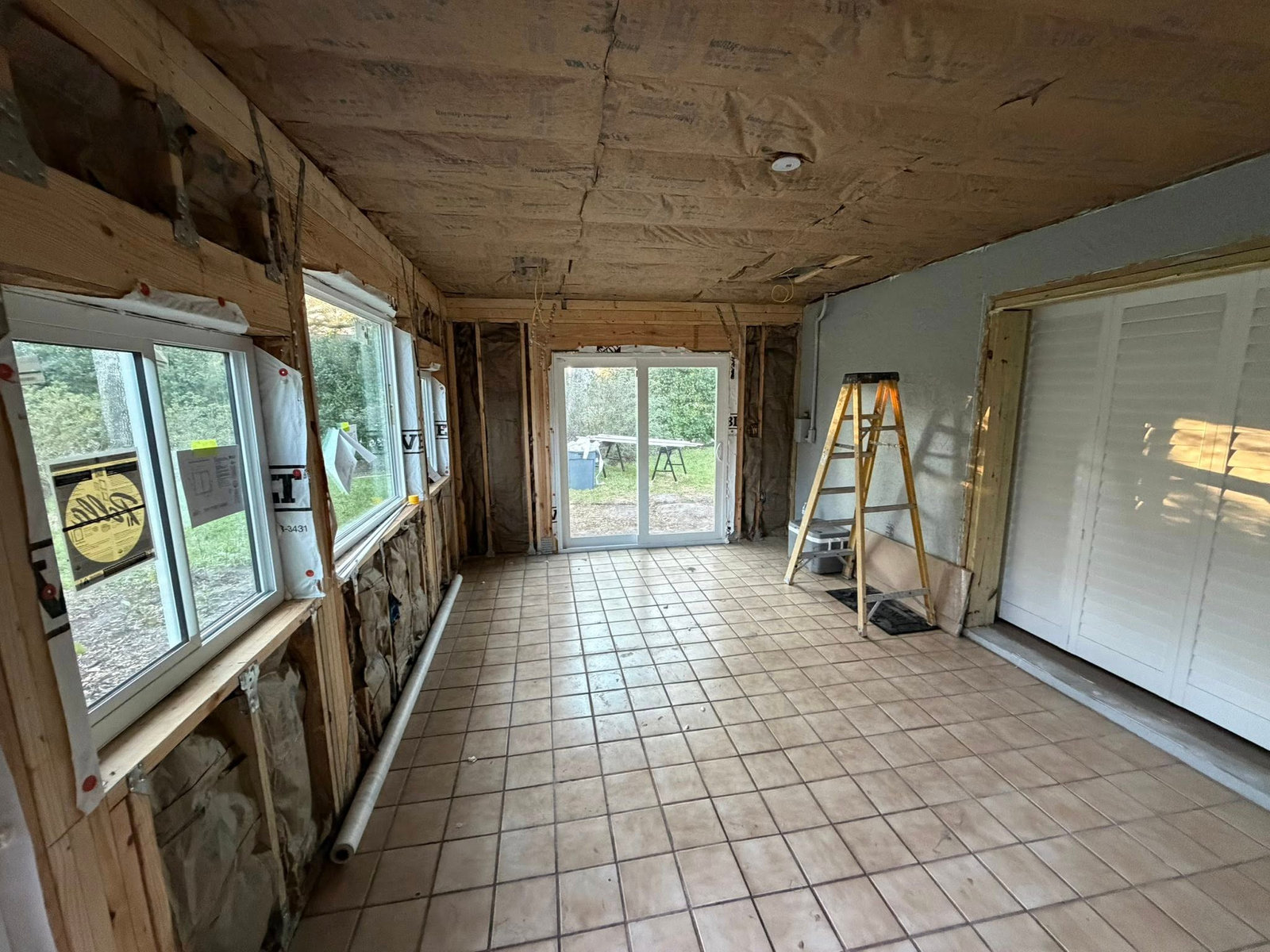 Enclosed patio stripped to the studs before renovation